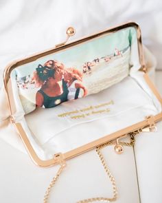 a purse with an image of a woman on the front is sitting on a white surface