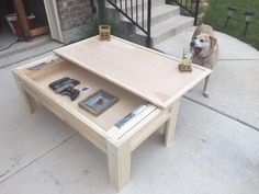 a dog standing next to a coffee table with books and magazines on it in front of a house