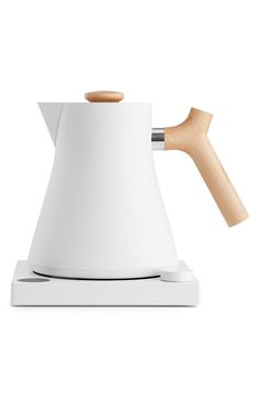 a white coffee pot with a wooden handle on it's side and the top half turned upside down