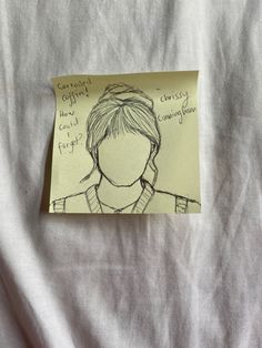 a piece of paper with a drawing of a woman's face on it