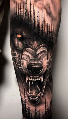 a man's leg with a wolf and trees on it