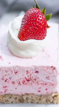 a close up of a piece of cake with a strawberry on top