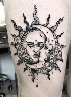 a man's thigh with a sun and moon tattoo design on the side of his leg