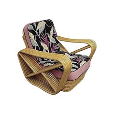 a wicker chair with floral fabric on the back and seat cushion is shown in front of a white background