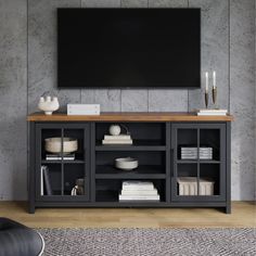 an entertainment center with shelves and a flat screen tv mounted on the wall above it