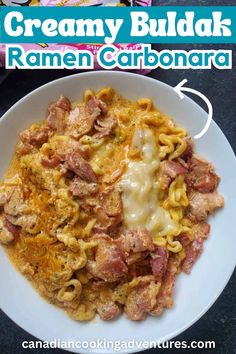 a white plate topped with pasta covered in ham and cheese