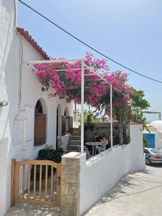 a white building with pink flowers on it