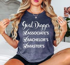 a woman sitting on top of a bed wearing a t - shirt that reads, good digger associates bachelors master's