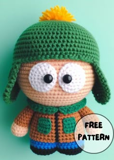 a crocheted stuffed animal wearing a green hat and scarf