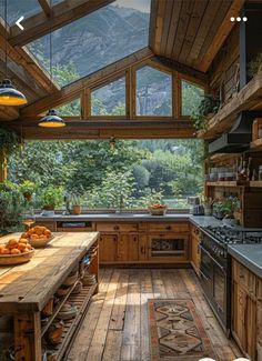 a kitchen with wooden floors and an open roof area that has lots of natural light coming in from the windows