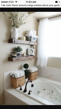 two baskets are sitting on the edge of a bathtub in front of a window