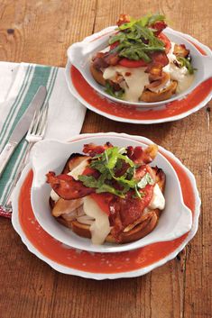 two plates filled with food on top of a wooden table