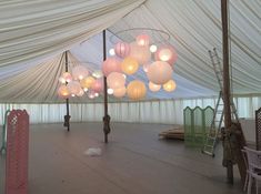 the inside of a tent with many lights hanging from it