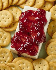 crackers and cheese with strawberry jam on them