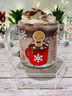 a glass mug filled with hot chocolate and marshmallows