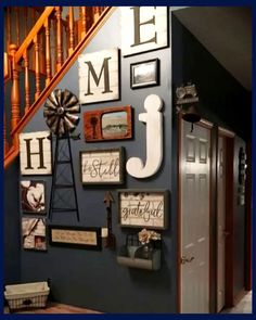 the entryway is decorated with pictures and signs on the wall, along with a wooden bench