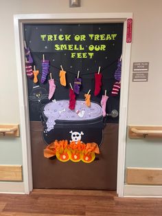 trick or treat smell our feet on halloween door decorating the entrance to an office