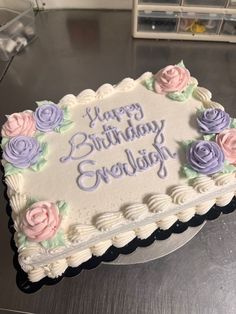 a birthday cake with frosting and flowers on it