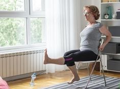 a woman sitting on a chair with her leg in the air