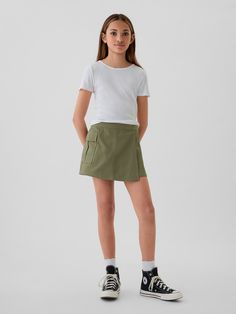 Smooth woven cotton-Tencel blend skort.  E-waist at back, concealed hook and bar closure at front.  Cargo pocket.  Inner shorts, wrap-style front.  Classic, easy fit.  Hits above the knee. Cotton School Shorts With Pockets, School Cotton Shorts With Pockets, Cotton Mini Skort With Side Pockets, Mini Skort With Side Pockets In Cotton, Fitted Cotton Shorts By Gap, Gap Fitted Cotton Shorts, Casual Cotton Skort With Cargo Pockets, Casual Cotton Skort With Side Pockets, Spring School Shorts With Pockets