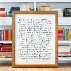 a framed poem is sitting in front of bookshelves