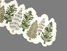 three christmas tree napkins with holly and mist