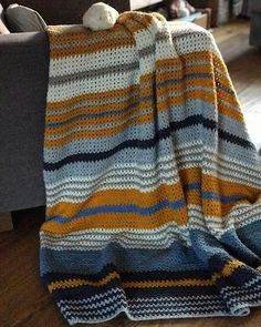 a blanket that is on the floor next to a couch