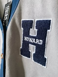 Show your Bison pride with this stylish and comfortable cardigan sweater, perfect for any Howard University enthusiast. Made with the highest quality materials, this sweater is designed to keep you warm and cozy while representing your alma mater or supporting your favorite HU student. Features:- Official Howard University logo embroidered on the chest- Large "H" Chenille patch- Classic cardigan design with a tortoise shell button-up front- Two front pockets (deep enough to fit a phone and other