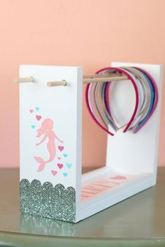 a white box with pink and blue designs on it sitting on top of a table