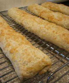 some bread sticks are cooling on a wire rack