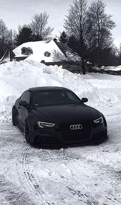 a black car is parked in the snow