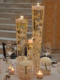 the centerpieces are decorated with flowers and candles