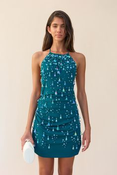 An adorned mini dress with droplet shaped beads, a high neck and an open upper back. — Mini length — Ruching throughout — Halter neck ties — Lower center back zip Droplet Dress, Artemis Dress, Hoco 2024, Beaded Mini Dress, Evening Flats, Hippie Girl, Cult Gaia, Neck Ties, White Summer