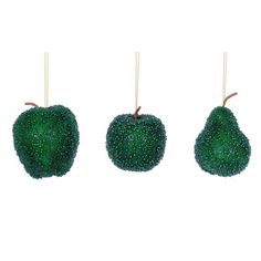 three pieces of green fruit hanging from clothes pins