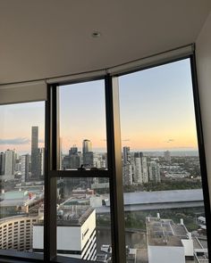 the view from an office building looking out onto a cityscape at sunset or dawn