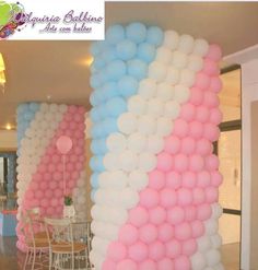 the balloon columns are decorated with pink, blue and white balloons