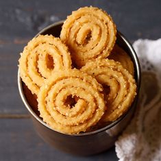 some kind of food that is in a bowl on a black table with a doily