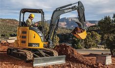 a man in a yellow hard hat is on a construction site with a bulldozer