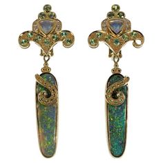 These lovely Paula Crevoshay 18k yellow gold and opal gemstone clip-one earrings are drop style having with a fleur-de-lis design at top, stamped and marked '18k'. Weight: 21.68 dwts. Authenticity Guarantee: All of our items are guaranteed to be authentic designer items. If found to be otherwise we will refund the purchase with a professional certification stating such, within 14 days of purchase. We can not guarantee the history of any piece, such as prior modifications or repairs. **Due to the Fine Jewellery Earrings, Opal Gemstone, Clip On Earrings, Jewelry Watches, 18k Gold, Jewelry Collection, Opal, Amethyst, Fine Jewelry