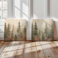 three canvases with trees on them in front of a white wall and wooden floor