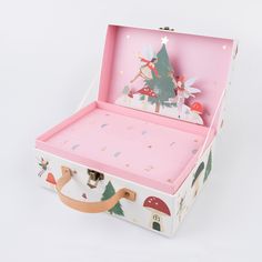 a pink and white box with an ornament in the lid that is shaped like a christmas tree