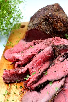 the meat is sliced up and ready to be served on the cutting board with parsley