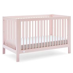 a pink baby crib with white sheets on the bottom and side rails, in front of a white background