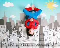 a man is upside down on the ground in front of a cityscape with buildings