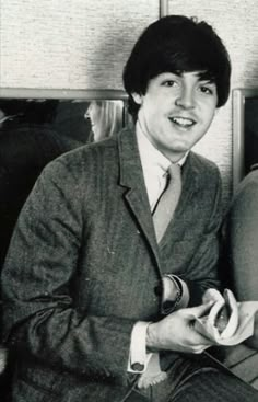 a man in a suit and tie sitting down