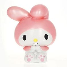 a pink and white hello kitty figurine sitting on top of a table