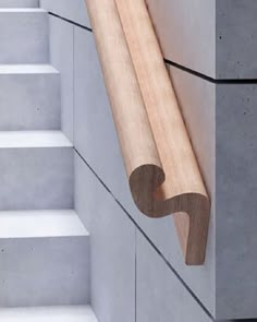 a wooden stick sticking out of the side of a wall next to some white steps