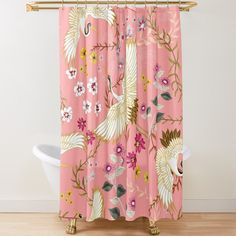 a pink shower curtain with white birds and flowers on it, in front of a bathtub