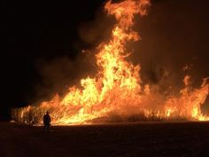 a person standing in front of a large fire