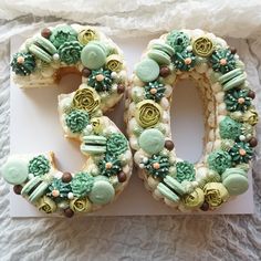 a cake shaped to look like the number 50 is decorated with green and brown icing